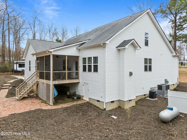 back of property featuring a ceiling fan, a sunroom, a shingled roof, crawl space, and stairs