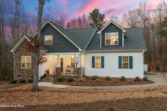 craftsman house with covered porch and roof with shingles