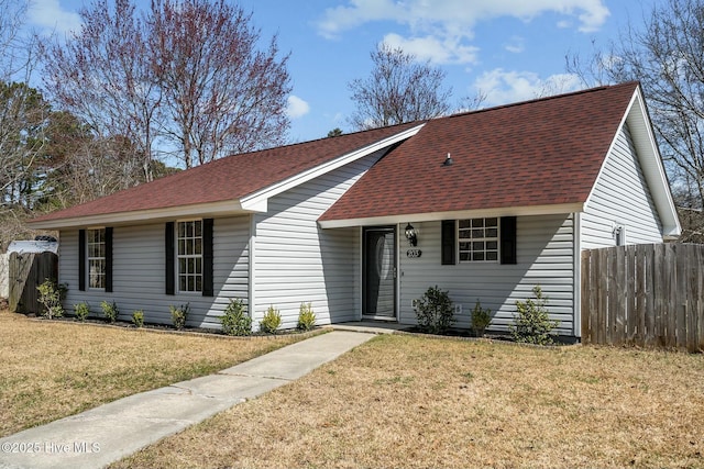 ranch-style house with roof with shingles, a front lawn, and fence