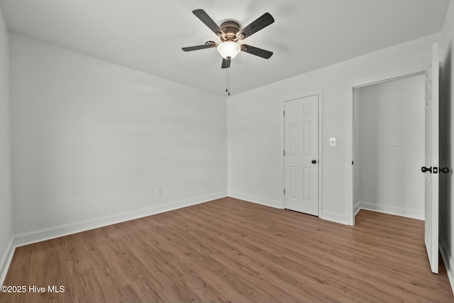 unfurnished bedroom featuring a ceiling fan, wood finished floors, and baseboards