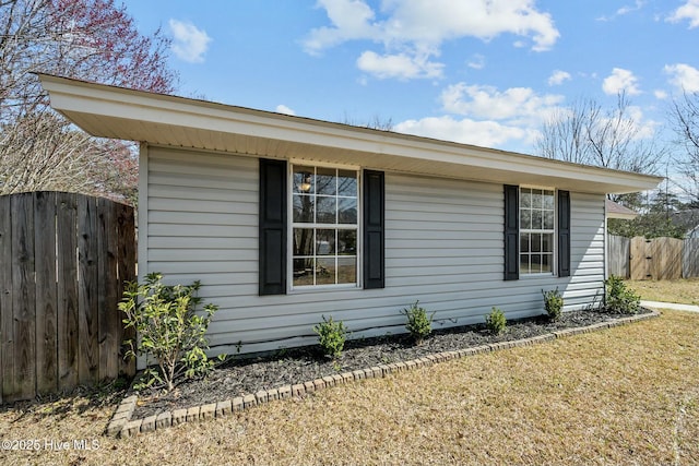 view of property exterior featuring fence