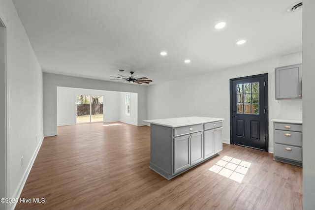 kitchen featuring a wealth of natural light, light wood-type flooring, gray cabinetry, and visible vents