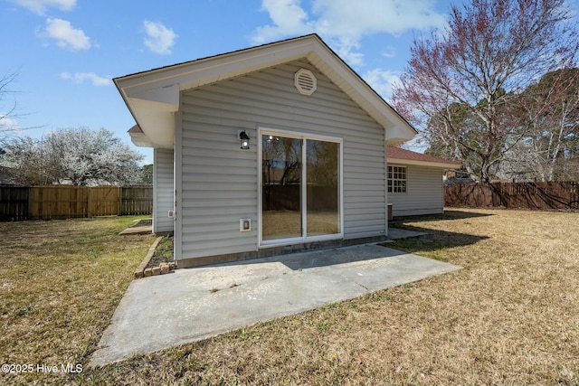 rear view of house featuring a patio, a lawn, and fence