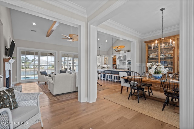 5151 Creswell Dr, Leland, NC 28451 - dining area with ceiling fan, light wood-style flooring, a chandelier, and crown molding