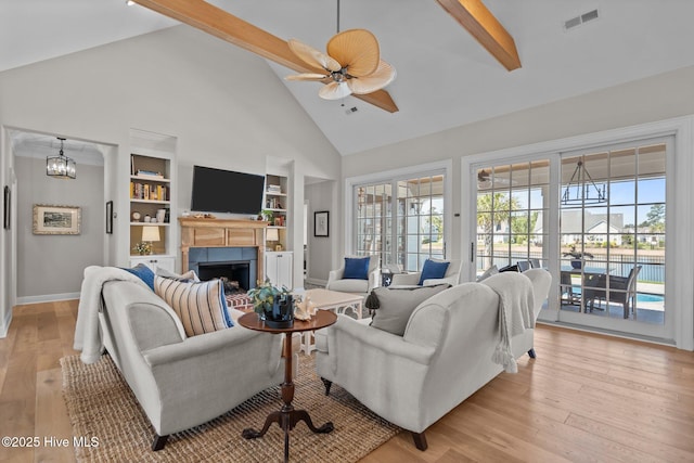 5151 Creswell Dr, Leland, NC 28451 - living room with high vaulted ceiling, ceiling fan, built in shelves, a fireplace, and beam ceiling
