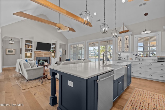 5151 Creswell Dr, Leland, NC 28451 - kitchen with a ceiling fan, stainless steel dishwasher, a sink, white cabinetry, and beam ceiling
