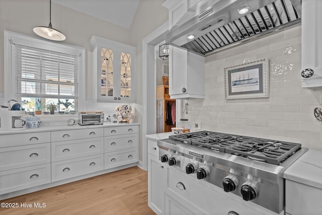 5151 Creswell Dr, Leland, NC 28451 - kitchen with wall chimney range hood, stainless steel gas stovetop, light countertops, and white cabinets