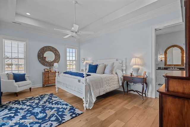 5151 Creswell Dr, Leland, NC 28451 - bedroom with light wood-type flooring, a sink, recessed lighting, baseboards, and a tray ceiling