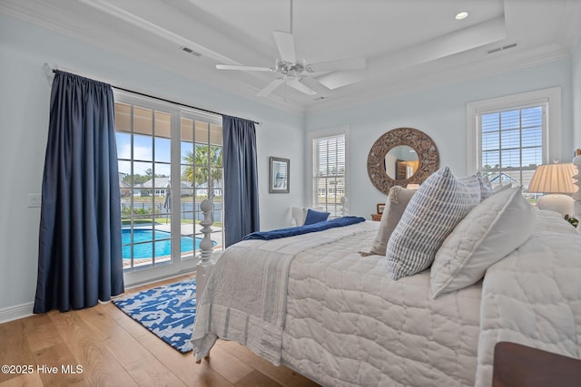 5151 Creswell Dr, Leland, NC 28451 - bedroom featuring wood finished floors, access to exterior, crown molding, a tray ceiling, and ceiling fan
