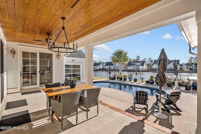 5151 Creswell Dr, Leland, NC 28451 - fenced backyard with a patio area, outdoor dining space, ceiling fan, and a water view