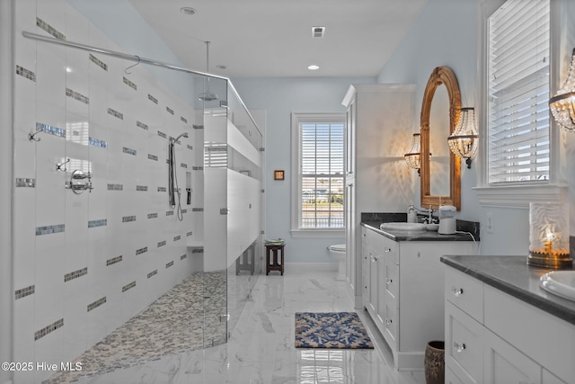 5151 Creswell Dr, Leland, NC 28451 - full bath featuring a stall shower, two vanities, marble tiled flooring, toilet, and baseboards