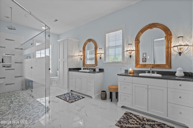 5151 Creswell Dr, Leland, NC 28451 - full bathroom with a shower stall, two vanities, toilet, and marble finish floors