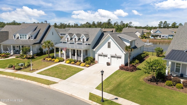 5151 Creswell Dr, Leland, NC 28451 - view of front facade with covered porch, a residential view, a standing seam roof, concrete driveway, and a front lawn