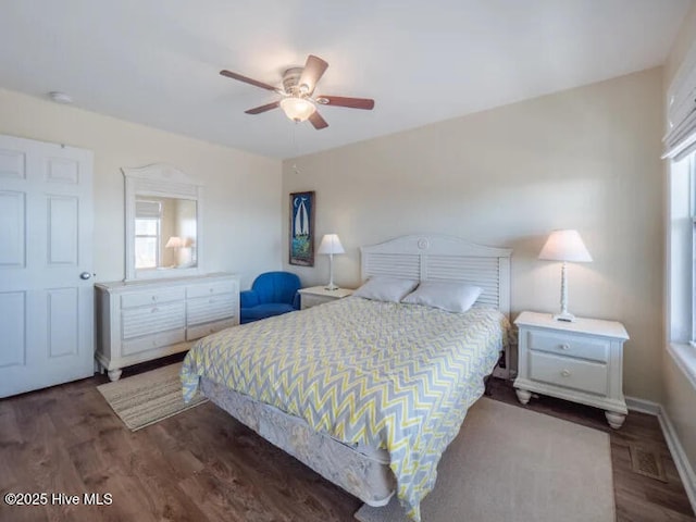 bedroom featuring ceiling fan, visible vents, multiple windows, and wood finished floors