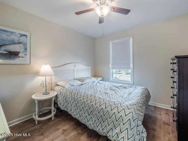 bedroom with baseboards, wood finished floors, and a ceiling fan