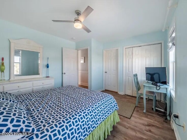 bedroom featuring multiple windows, wood finished floors, and ceiling fan