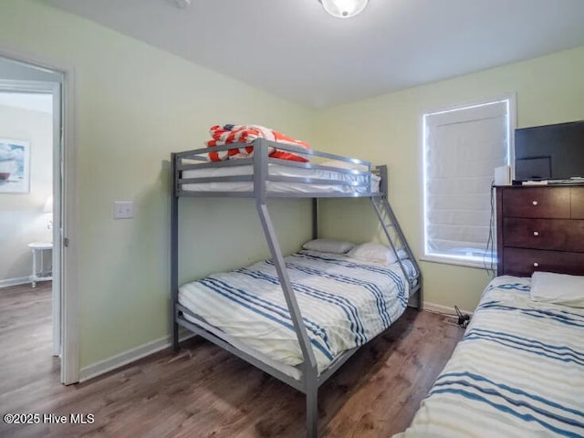 bedroom with wood finished floors and baseboards