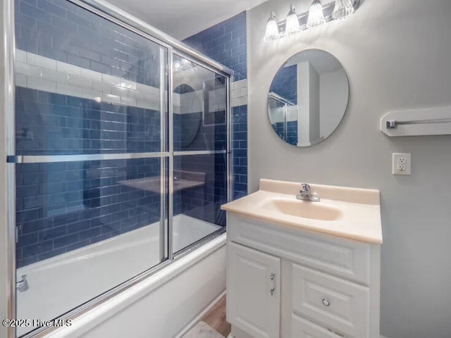 bathroom featuring enclosed tub / shower combo and vanity