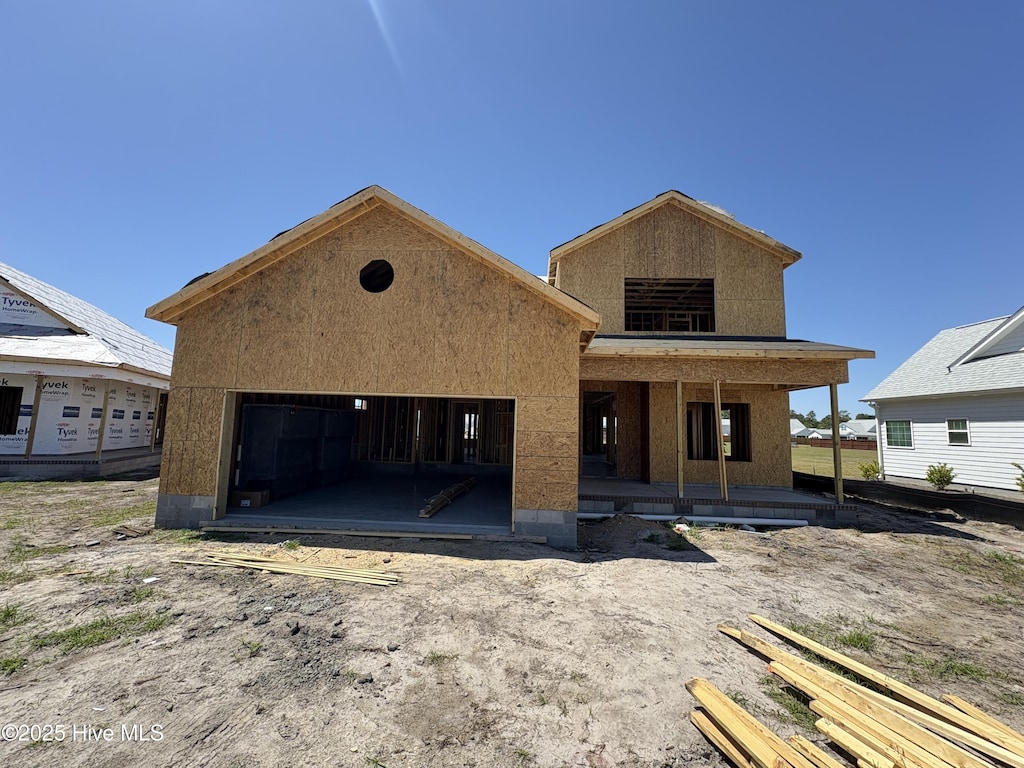 344 Bluebird Ln, Hampstead, NC 28443 - property under construction with covered porch, a garage, and stucco siding