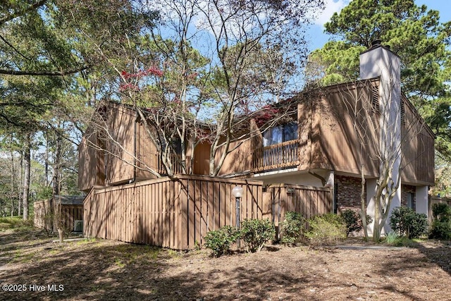 1024 Birch Creek Dr, Wilmington, NC 28403 - view of side of property featuring stucco siding and a chimney