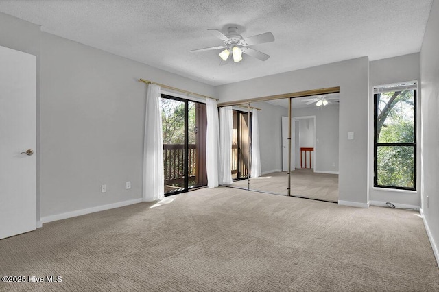 unfurnished bedroom with baseboards, light carpet, ceiling fan, a textured ceiling, and access to outside