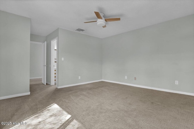 unfurnished room with visible vents, carpet flooring, baseboards, and ceiling fan