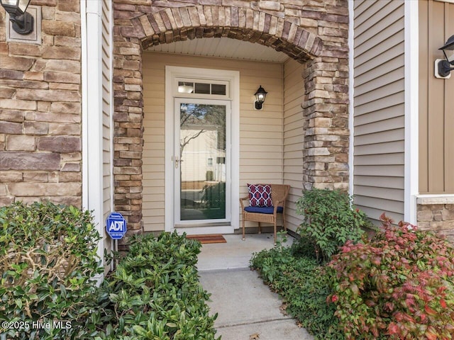 entrance to property featuring stone siding