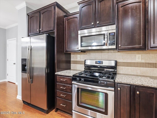 kitchen with stainless steel appliances, ornamental molding, decorative backsplash, light wood-type flooring, and dark brown cabinetry