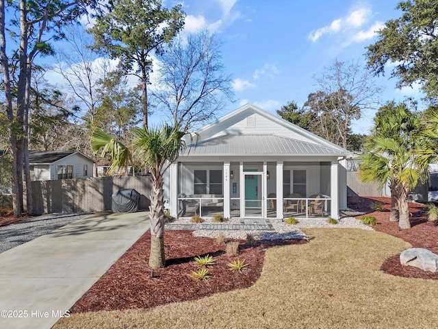 view of front of home with fence and a sunroom