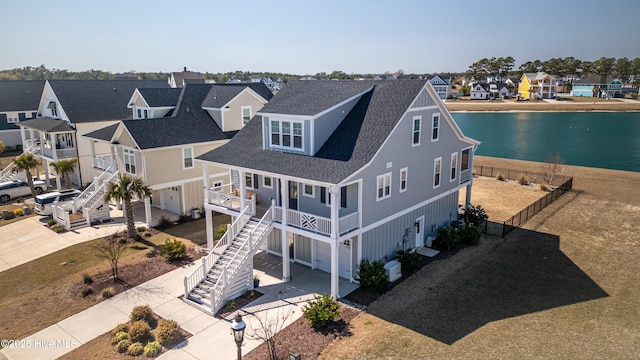 drone / aerial view with a residential view and a water view