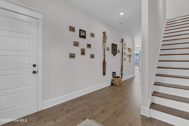 interior space with stairway, recessed lighting, baseboards, and wood finished floors