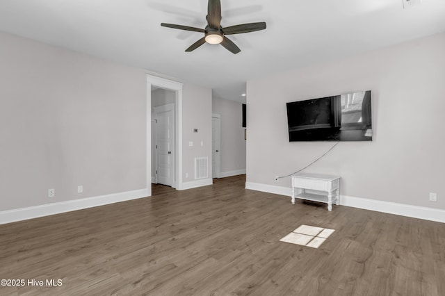 unfurnished living room with baseboards, wood finished floors, visible vents, and ceiling fan