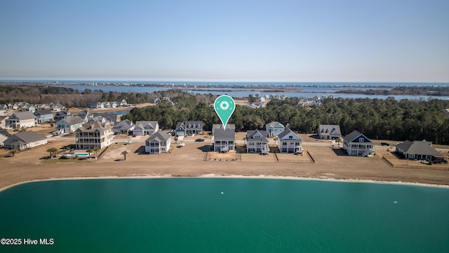 drone / aerial view with a water view and a residential view