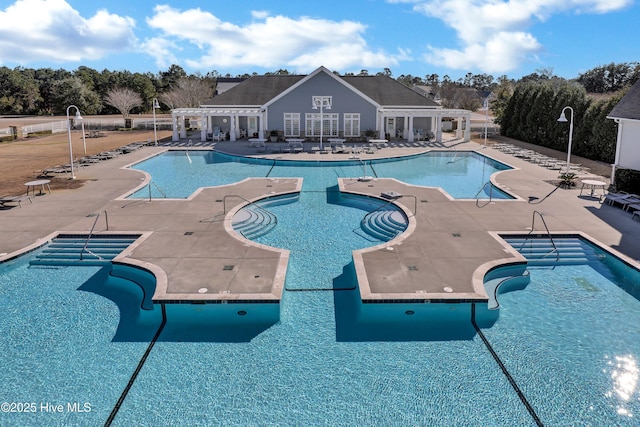 pool featuring a patio, a jacuzzi, and a pergola