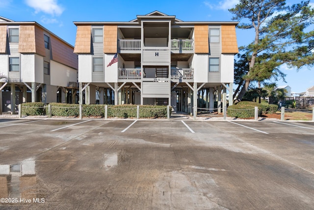 view of building exterior with uncovered parking