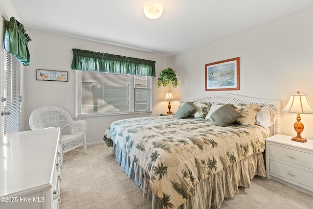 bedroom with light carpet and baseboards