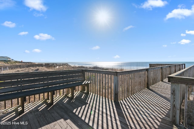 wooden terrace featuring a water view