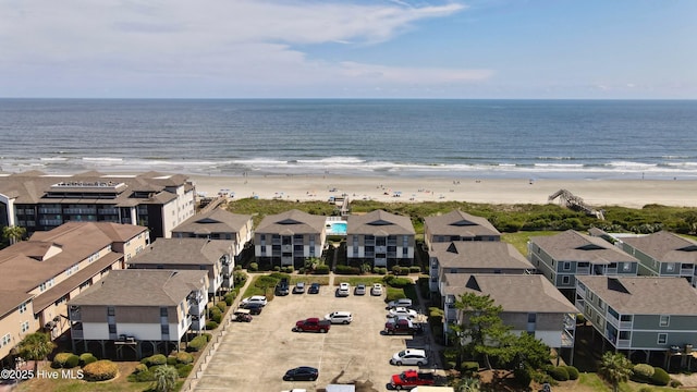 drone / aerial view with a residential view, a beach view, and a water view