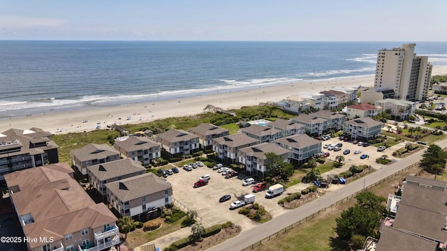 drone / aerial view with a water view and a beach view