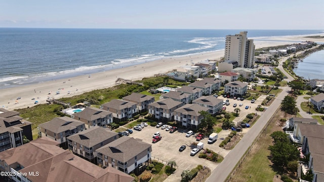 birds eye view of property featuring a beach view and a water view