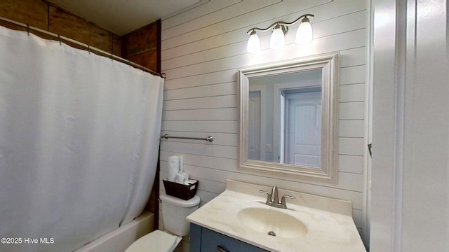 205 Fayetteville Ave Unit 1, Carolina Beach, NC 28428 - full bathroom with vanity, wood walls, toilet, and shower / bathtub combination with curtain