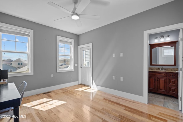 205 Fayetteville Ave Unit 1, Carolina Beach, NC 28428 - office space featuring a sink, light wood-type flooring, a ceiling fan, and baseboards