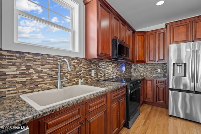 205 Fayetteville Ave Unit 1, Carolina Beach, NC 28428 - kitchen with stainless steel fridge, black range with electric cooktop, a sink, backsplash, and recessed lighting