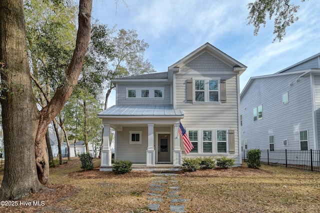 craftsman-style home featuring metal roof, a porch, a standing seam roof, and fence