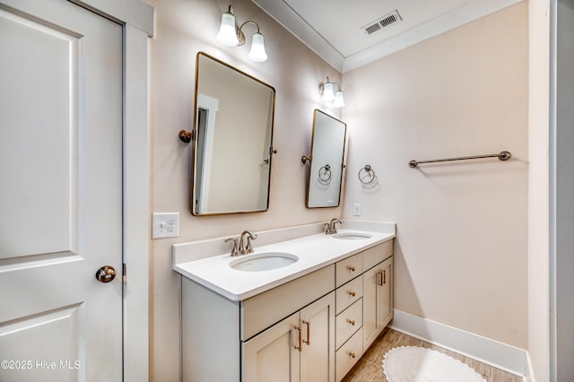 full bath with a sink, visible vents, baseboards, and double vanity