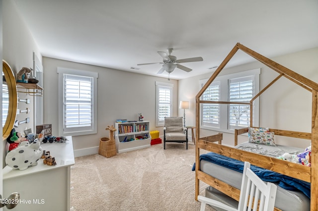 carpeted bedroom with a ceiling fan, visible vents, and baseboards