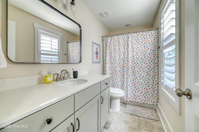 bathroom featuring a shower with shower curtain, toilet, and vanity