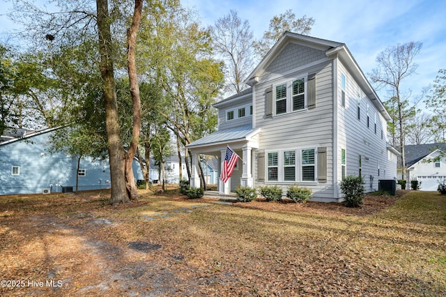 view of front of house featuring metal roof and central AC