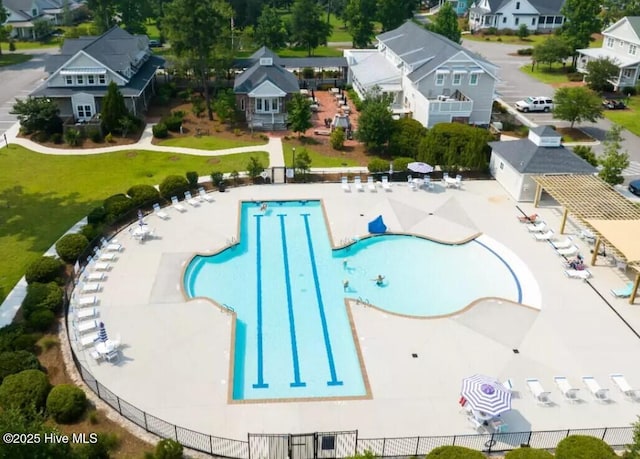 view of swimming pool featuring a residential view and fence