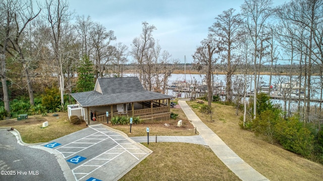 view of home's community featuring a yard and a water view